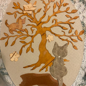 a delightful bookmark made from birch bark, featuring a tree, kitten on the tree, cat sitting under the tree, and looking at the kitten