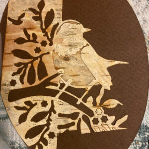 Here's a description of a beautiful bookmark made from birch bark, featuring a bird on a tree design